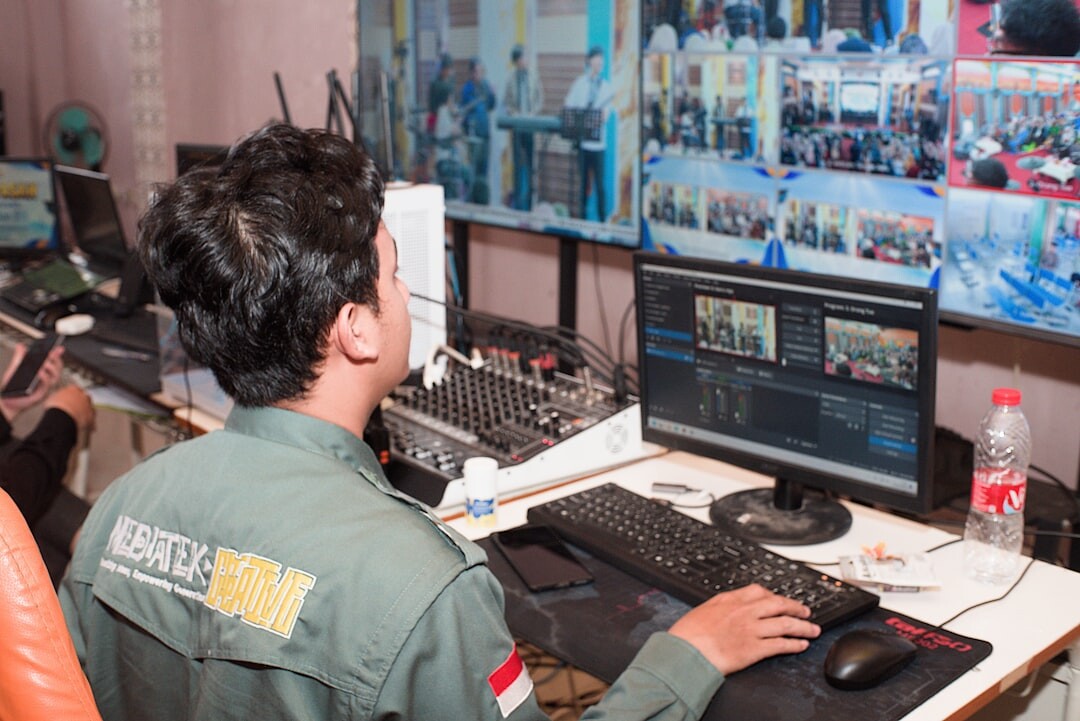Broadcast control room wide shot with screens